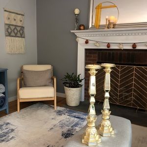 Ornate and mirrored gold pillar candlesticks